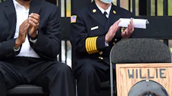 Juan 'Scooter' Blakely (left), a photographer with the Erie, PA, Bureau of Fire, and Erie Fire Chief Joe Walko attend the Workers Memorial Day event Wednesday at Perry Square. Blakely's father, Erie firefighter Willie Blakely, died Oct. 24, 1982, and during Wednesday's ceremony, Blakely's death was declared a line-of-duty death so that he could be afforded the honors given to those in public safety who sacrificed their lives in the performance of their duties.