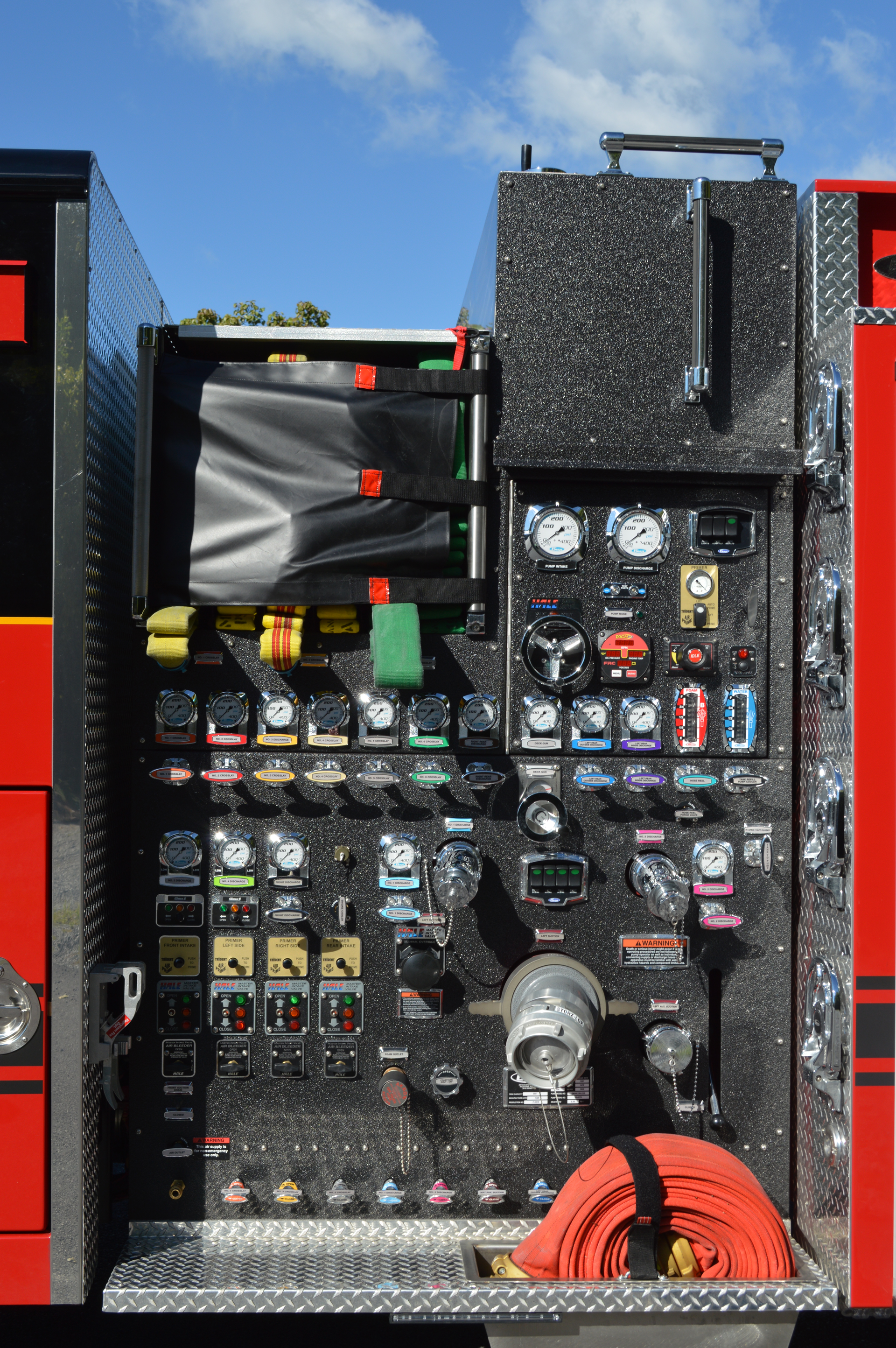This pump panel was built by Four Guys Fire Apparatus for the Hagerstown, MD, Fire Department. Note how the crosslay discharge piping extends to the side of the panel and how the arrangement of the pump throttle and relief valve are below the master gauges and intake valve controls at the lower left corner.