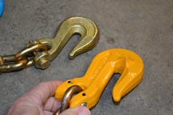 Premise 2. The gold grab hook (top left) is a standard design. The yellow grab hook has ears on both sides. Both are Grade 8, and both were tested to failure. The link that was placed into the throat of the grab hook that had ears failed at the end of one ear, not at its weld. The grab hook itself also received damage in this test. Premise 2. The gold grab hook (top left) is a standard design. The yellow grab hook has ears on both sides. Both are Grade 8, and both were tested to failure. The link that was placed into the throat of the grab hook that had ears failed at the end of one ear, not at its weld. The grab hook itself also received damage in this test.