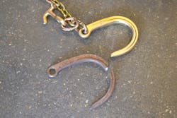 The 3-year old, used and corroded J-hook (bottom) with a WLL of 5,400 lbs. deformed open during its&rsquo; destructive test prior to a fracturing failure at a peak load of over 20,000 lbs.. Note how much larger/wider the opening is compared to the new J-hook. They were exactly the same prior to the test.