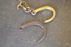 The 3-year old, used and corroded J-hook (bottom) with a WLL of 5,400 lbs. deformed open during its’ destructive test prior to a fracturing failure at a peak load of over 20,000 lbs.. Note how much larger/wider the opening is compared to the new J-hook. They were exactly the same prior to the test. The 3-year old, used and corroded J-hook (bottom) with a WLL of 5,400 lbs. deformed open during its’ destructive test prior to a fracturing failure at a peak load of over 20,000 lbs.. Note how much larger/wider the opening is compared to the new J-hook. They were exactly the same prior to the test.