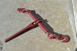 Premise 6. The 3/8-inch Grade 7 ratchet-style load binders that were tested had a WLL of 6,600 lbs. One destructive test resulted in failure at 27,669 lbs., as the threaded end pulled free of the body of the binder. The inspection hole on this end of the ratchet-style load binder allows monitoring of the extension of the threaded rod. This hole still shows the threaded rod inside and, therefore, indicates that there is sufficient thread contact at this end to achieve its WLL. Premise 6. The 3/8-inch Grade 7 ratchet-style load binders that were tested had a WLL of 6,600 lbs. One destructive test resulted in failure at 27,669 lbs., as the threaded end pulled free of the body of the binder. The inspection hole on this end of the ratchet-style load binder allows monitoring of the extension of the threaded rod. This hole still shows the threaded rod inside and, therefore, indicates that there is sufficient thread contact at this end to achieve its WLL.