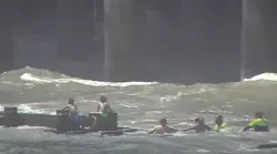 An off-duty Atlantic City, NJ, firefighter helped police and others to rescue three siblings who were struggling in the ocean and were eventually clinging to a drainage pipe Tuesday.