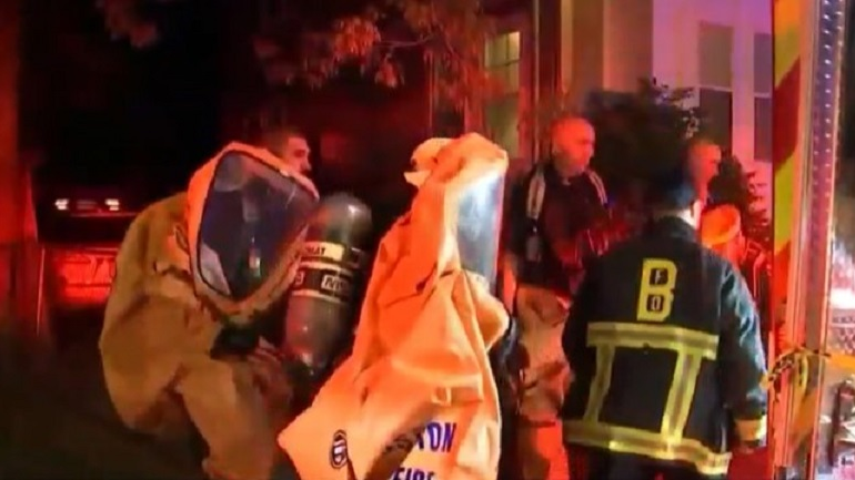 Two Boston firefighters and four residents were decontaminated after a Level 3 hazmat incident was declared when a man brought an unknown chemical to a fire station in the city's Roslindale neighborhood late Monday.