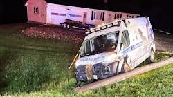 Live electrical wires trapped three people inside an East Millinocket, ME, ambulance after the unit collided with a utilty pole in Bridgewater late Monday.
