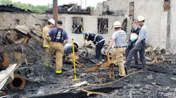 Investigators scour the scene Tuesday of a multi-alarm fire that broke out at a shopping plaza in Solomons, MD, late Monday, causing nearly $3 million in damage.