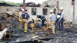 Investigators scour the scene Tuesday of a multi-alarm fire that broke out at a shopping plaza in Solomons, MD, late Monday, causing nearly $3 million in damage. Investigators scour the scene Tuesday of a multi-alarm fire that broke out at a shopping plaza in Solomons, MD, late Monday, causing nearly $3 million in damage.