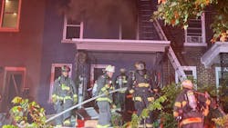 D.C. Fire and EMS firefighters pulled a critically injured woman from the first floor of a burning rowhouse early Wednesday.