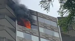 Dallas firefighters were able to contain a multi-alarm fire in a apartment high-rise Tuesday to a single unit in the complex.