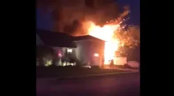 Flames from a Long Island, NY, house fire caused two propane tanks to explode Thursday.