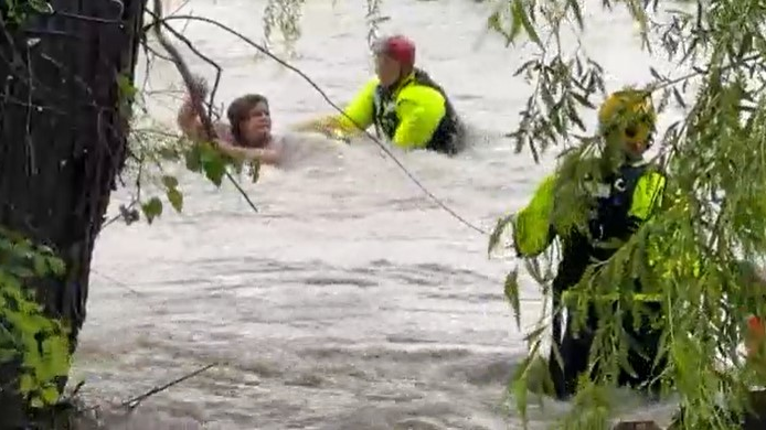 Fort Worth, TX, firefighters rescued a woman caught in fast-moving flooding after her minivan was swept away in the high waters Monday.