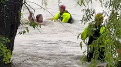 Fort Worth, TX, firefighters rescued a woman caught in fast-moving flooding after her minivan was swept away in the high waters Monday.