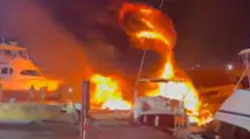 Miami firefighters put out a large fire that destroyed two abandoned yachts docked in a Miami River marina early Thursday.