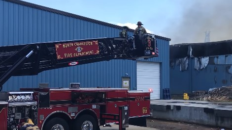 Firefighters from multiple departments battled a two-alarm fire that started on the warehouse dock of a cabinet business in North Charleston, SC, on Tuesday.