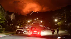 Flames from the Palisades Fire glow in the distance in Topanga, CA, northwest of Los Angeles, on May 15.