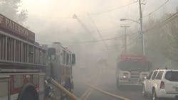 A firefighter was injured battling a four-alarm fire at a multi-family dwelling in Paterson, NJ on Sunday.