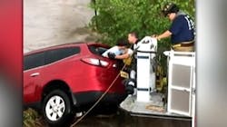 Portales, NM, firefighters rescue a mother and her children after their SUV was swept away by fast-moving floodwaters Saturday. Portales, NM, firefighters rescue a mother and her children after their SUV was swept away by fast-moving floodwaters Saturday.