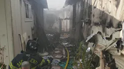 Sacramento, CA, firefighters battled a three-alarm fire that seriously damaged three homes and a pool house Friday.