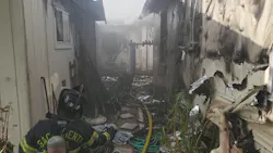 Sacramento, CA, firefighters battled a three-alarm fire that seriously damaged three homes and a pool house Friday.