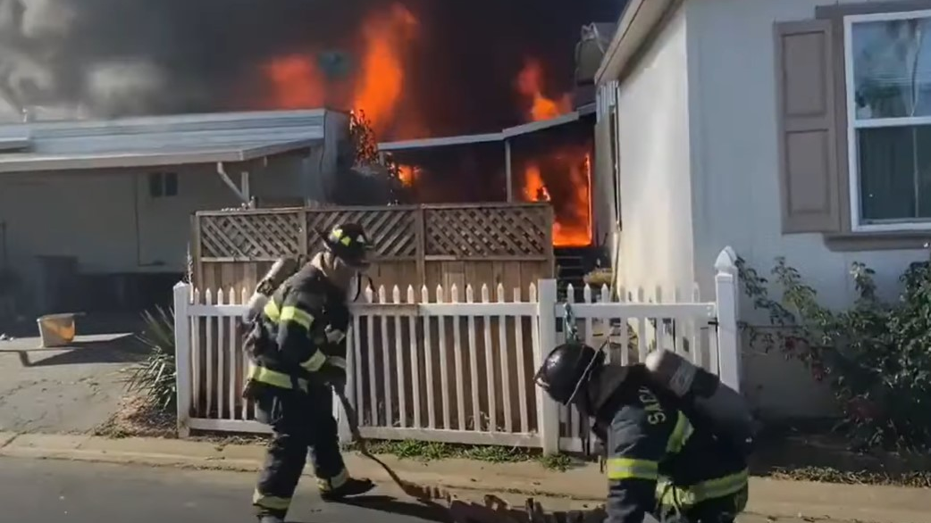 Sacramento, CA, firefighters battle a two-alarm fire that damaged four units in a mobile home park Tuesday.