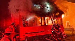 Webster, MA, firefighters used a neighbor's ladder to rescue a woman clinging to the roof of a burning three-family home late Wednesday.
