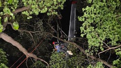 Whitewater, WI, firefighters used a rope system to rescue three people suspended 75 feet above the ground when their plane crashed in the Kettle Moraine Forest on Saturday.