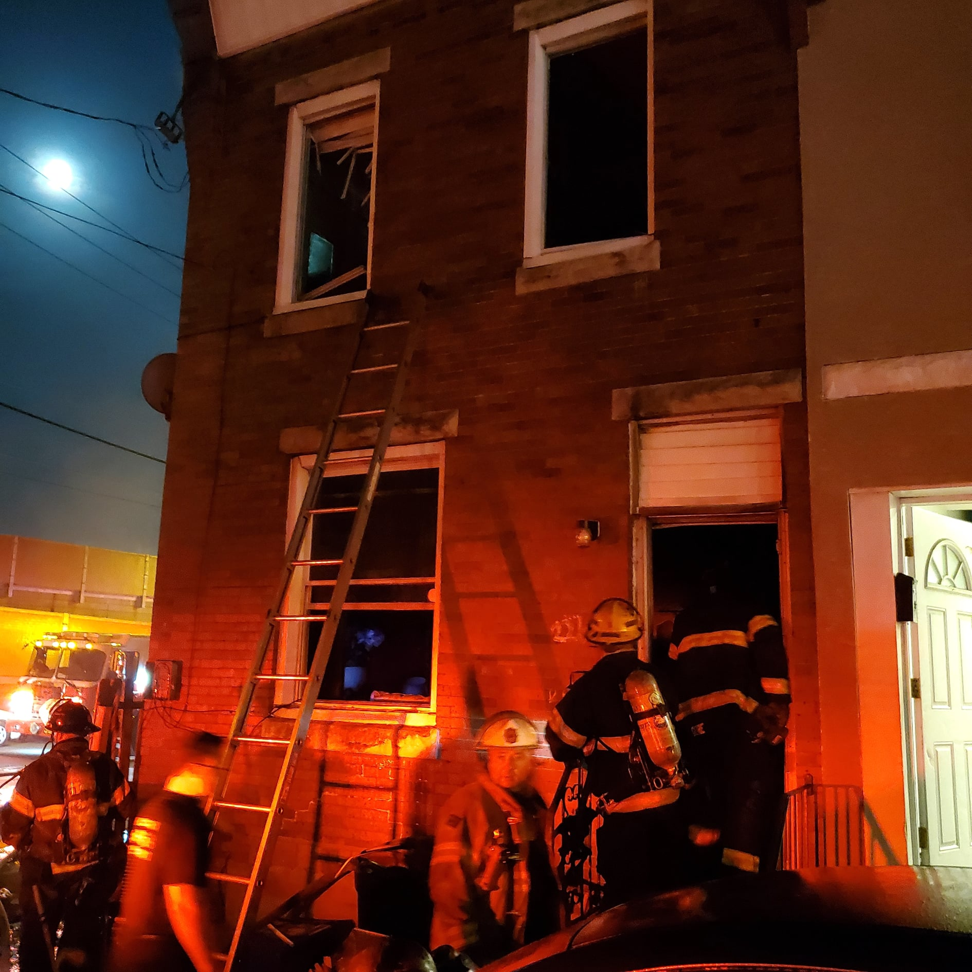 Philadelphia firefighters rescued two children hanging from a second-story window of a burning rowhouse in the city's Bridesburg neighborhood early Wednesday.