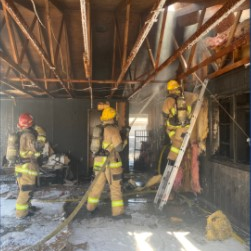 Two Phoenix firefighters suffered burns to their ears and hands battling a house fire Sunday.