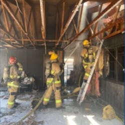 Two Phoenix firefighters suffered burns to their ears and hands battling a house fire Sunday.