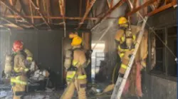 Two Phoenix firefighters suffered burns to their ears and hands battling a house fire Sunday.