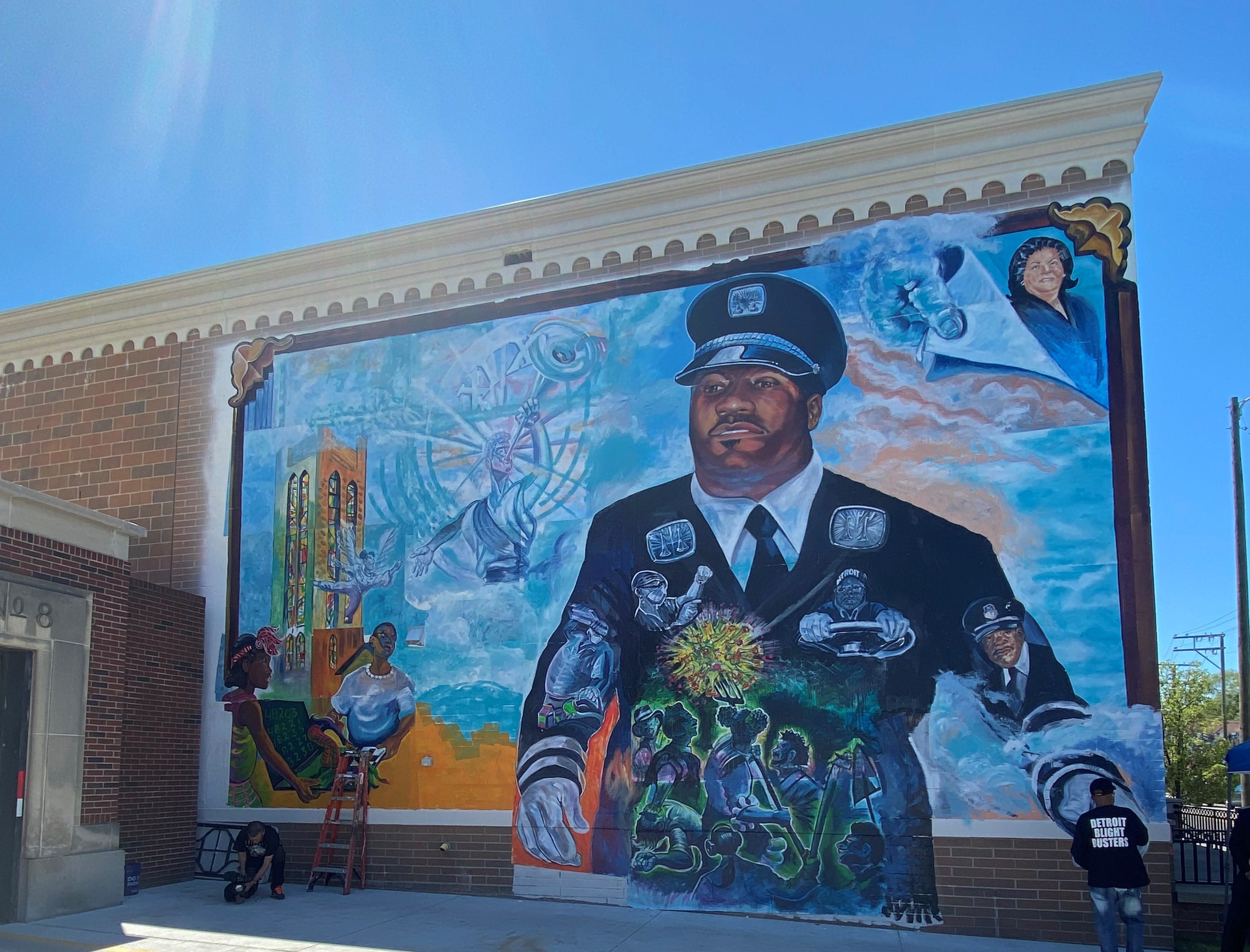 Detroit Fire Capt. Franklin Williams, who died last year from COVID-19, is featured on a mural honoring front-line workers who died from COVID-19 at the Arabic American and Chaldean Council's building in Detroit.