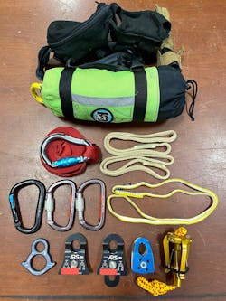 A variety of rescues can be facilitated via access to the following pieces of equipment, all of which can fit into the pouches that are shown: from top to bottom, a throw bag; a flip line; hollow-block Prusiks (2); locking carabiners of different shape (3); a sling; a Mini 8; pulleys (2) that can connect to form a double pulley; Prusik minding pulley; and a crossline reach grappling hook. A variety of rescues can be facilitated via access to the following pieces of equipment, all of which can fit into the pouches that are shown: from top to bottom, a throw bag; a flip line; hollow-block Prusiks (2); locking carabiners of different shape (3); a sling; a Mini 8; pulleys (2) that can connect to form a double pulley; Prusik minding pulley; and a crossline reach grappling hook.