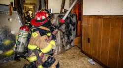 A firefighter of a rural department trains on moving hoselines with only two firefighters.