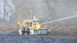 Firefighters from the International Falls Fire Department, together with the Minnesota Department of Natural Resources, responding to a wildfire on Rainy Lake’s Frank Island. The fire, which jumped across open water to Voyageurs National Park on the mainland, was quickly extinguished despite high winds and elevated fire danger conditions.