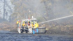 Firefighters from the International Falls Fire Department, together with the Minnesota Department of Natural Resources, responding to a wildfire on Rainy Lake’s Frank Island. The fire, which jumped across open water to Voyageurs National Park on the mainland, was quickly extinguished despite high winds and elevated fire danger conditions. Firefighters from the International Falls Fire Department, together with the Minnesota Department of Natural Resources, responding to a wildfire on Rainy Lake’s Frank Island. The fire, which jumped across open water to Voyageurs National Park on the mainland, was quickly extinguished despite high winds and elevated fire danger conditions.