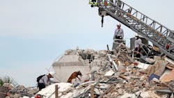 Firefighters work alongside K-9 units while searching the rubble of the Champlain Towers South Condo. Firefighters work alongside K-9 units while searching the rubble of the Champlain Towers South Condo.