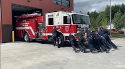 Clark-Cowlitz Fire Rescue firefighters push in a newly purchased apparatus to its Woodland, WA, station May 25, the first time the firehouse has received a new engine in 21 years.
