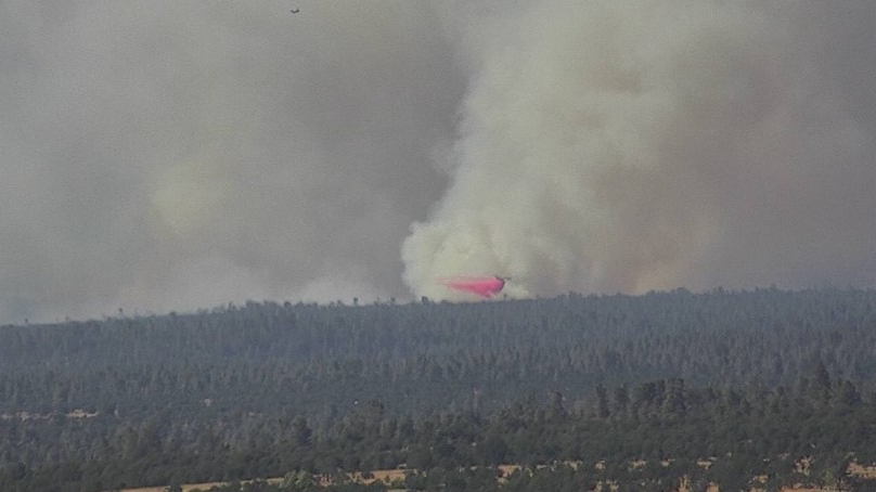 An air tanker douses the Cow Fire on Monday southeast of Millville, CA, in Shasta County.