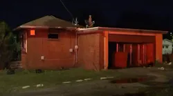 East St. Louis, IL, Firefighters rescued a woman suffering from burns who trapped inside her bathroom after her house caught fire Monday.