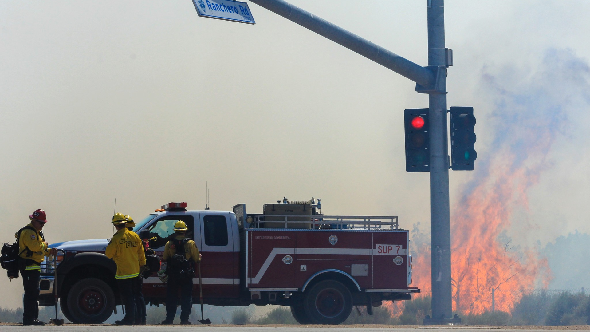 Firefighters battle the Farm Fire in Hesperia, CA, on Thursday.