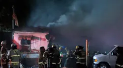 Firefighters from two departments stopped a fire from spreading throughout a Fresno, CA, mobile home community late Wednesday after flames destroyed two trailers and damaged at least two others.