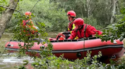 Biloxi, MS, and Harrison County firefighters rescue a kayaker who was hanging on to a tree after flipping over in a fast-moving, flooded creek Sunday.