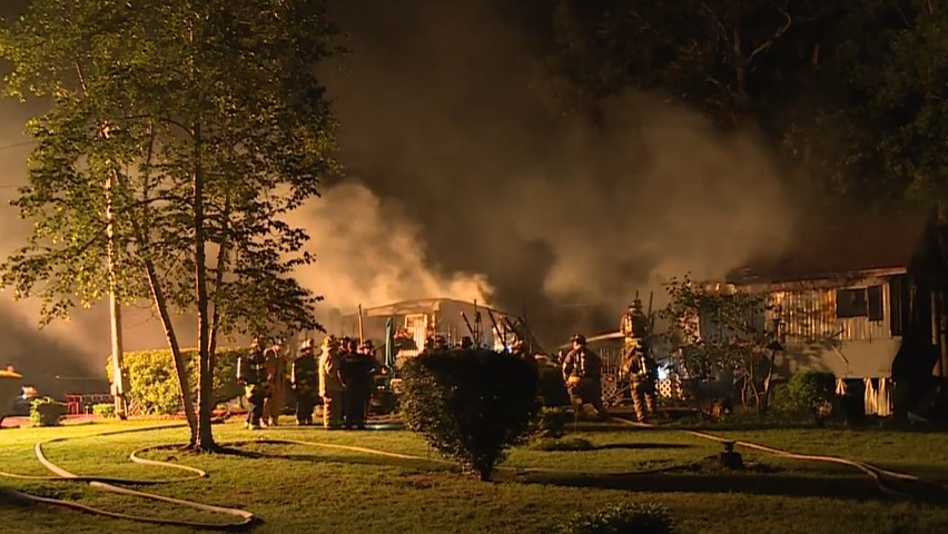 Two people died in a trailer home fire late Tuesday that had about 80 firefighters from more than a half-dozen departments responding.