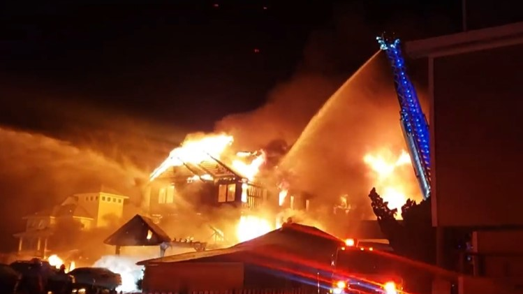 Firefighters from multiple departments battled a two-alarm fire that tore through a $4.9 million vacation home in Kill Devil Hills, NC, on Sunday.
