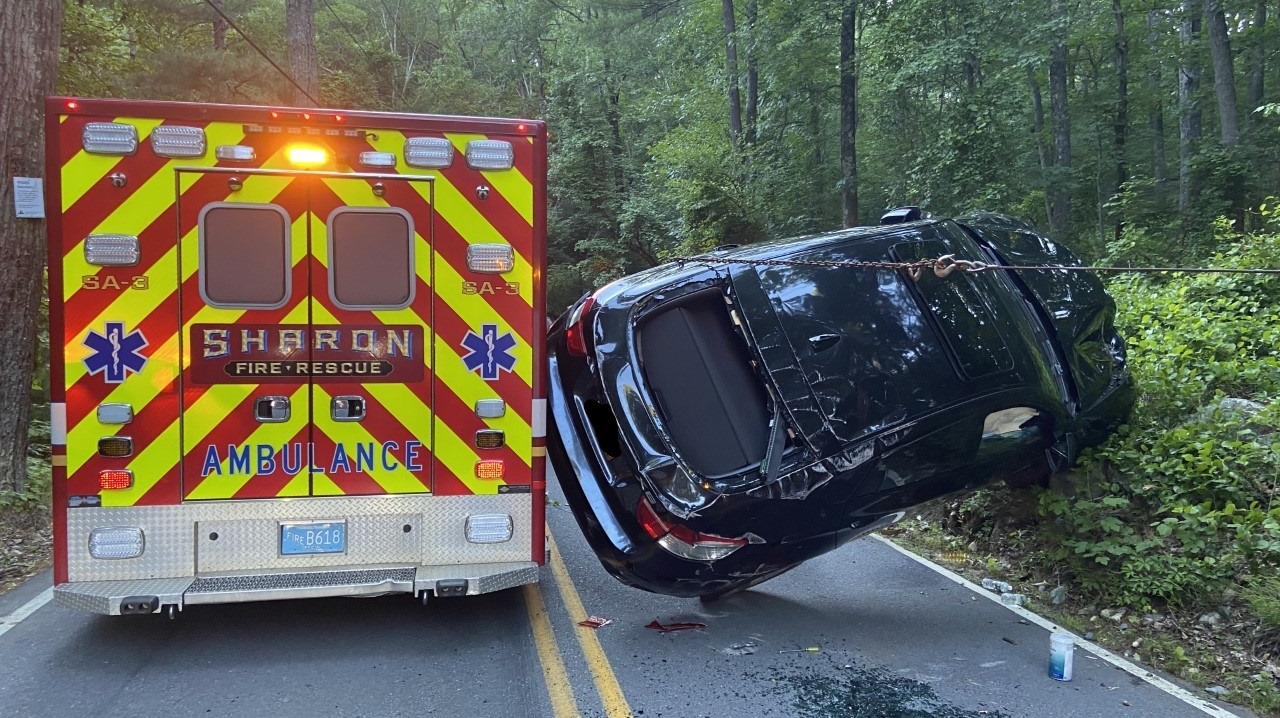 A car flipped on its side while trying to pass a Sharon, MA, Fire-Rescue ambulance at the scene of a previous crash.