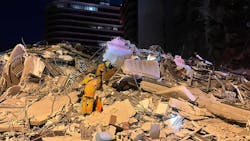 Miami-Dade firefighters search for survivors amid the rubble of a 12-story condo tower that partially collapsed in Surfside early Thursday.