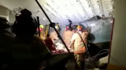 Miami-Dade firefighters work in the basement garage of the partially collapsed 12-story condo tower in Surfside on Thursday.