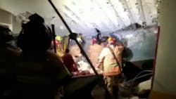 Miami-Dade firefighters work in the basement garage of the partially collapsed 12-story condo tower in Surfside on Thursday. Miami-Dade firefighters work in the basement garage of the partially collapsed 12-story condo tower in Surfside on Thursday.