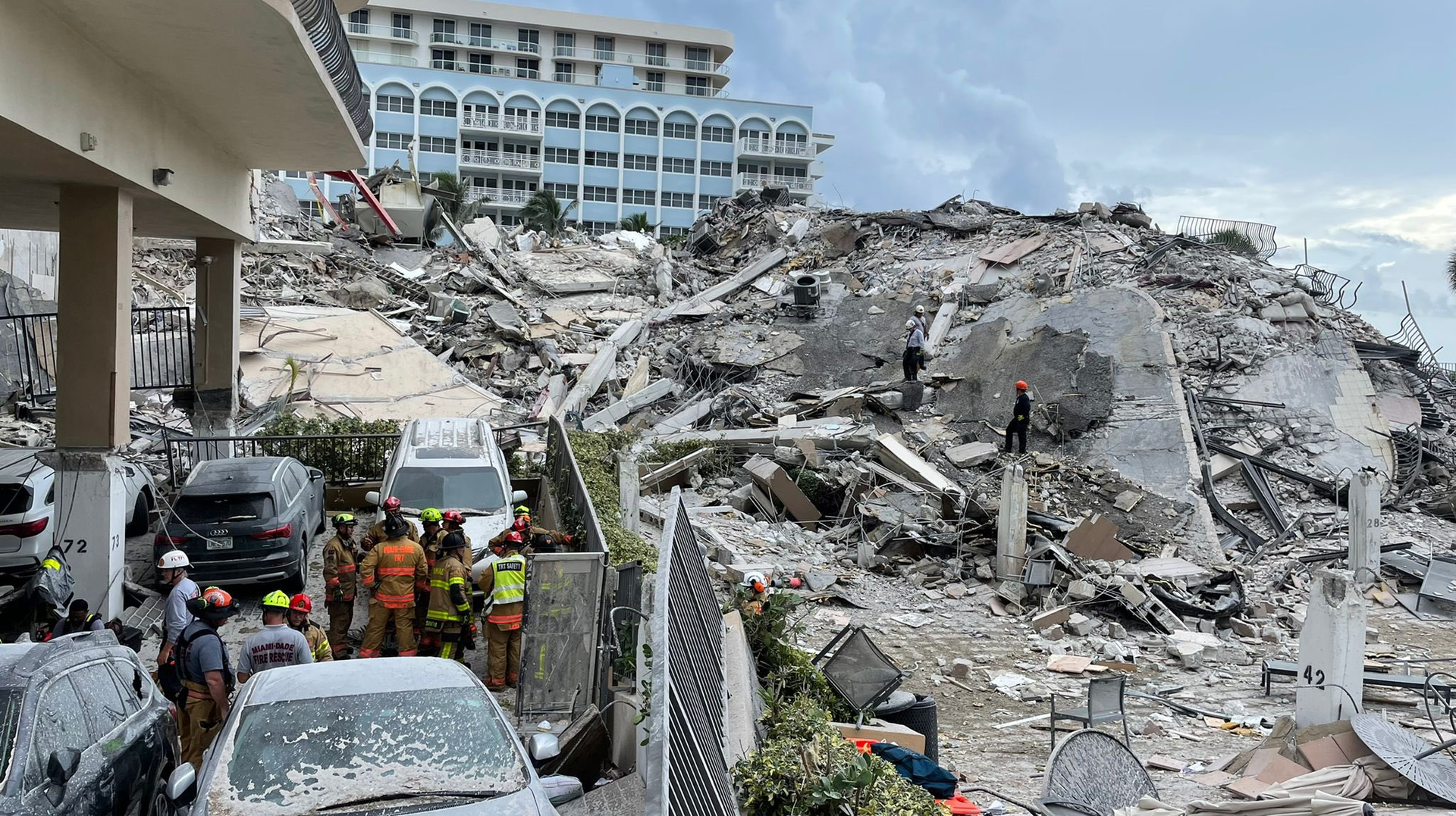 Rescue teams continue to search for survivors amid the rubble of the partially collapsed 12-story condo tower in Surfside, FL, on Friday.