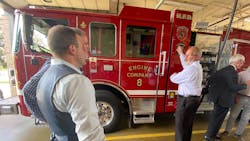 A member of the Pierce team shows guests at the announcement where the batteries are stored on the fire apparatus.